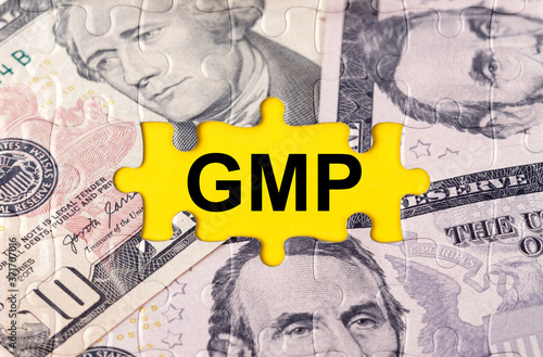 Puzzle with the image of dollars in the center of the inscription -GMP