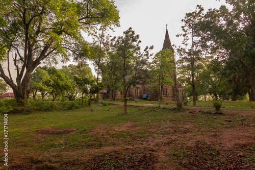 Old Anglican Church of British Era 1875 of  Pachmarhi, with a Lush Green Lawns photo