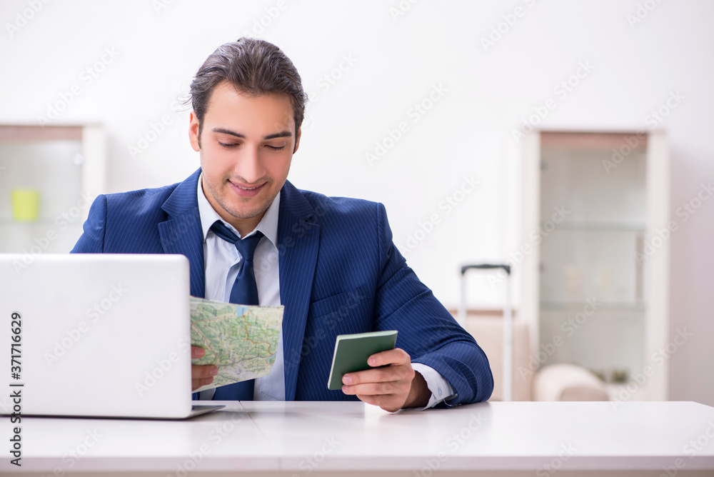 Young businessman holding passport preparing for trip Young businessman holding passport preparing for trip