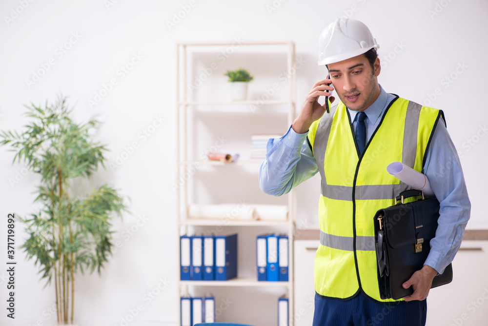 Young male architect working in the office Young male architect working in the office
