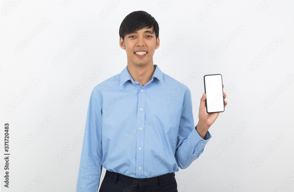 Young handsome asian business man showing smartphone with blank screen and smiling isolated on white background. Young handsome asian business man showing smartphone with blank screen and smiling isolated on white background.