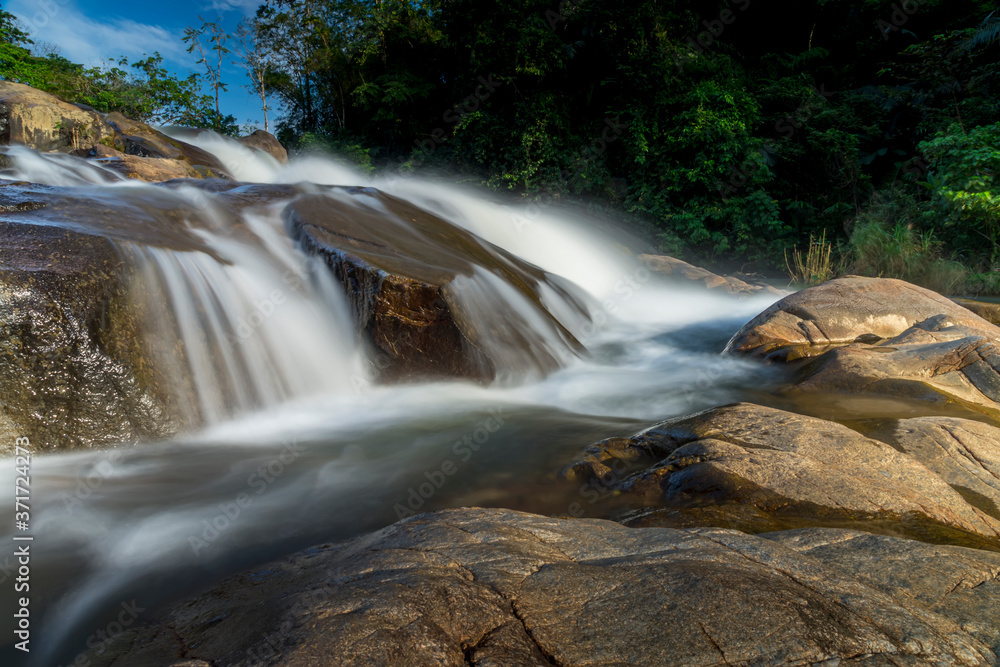 Fototapeta premium Small waterfall and stone with water motion.