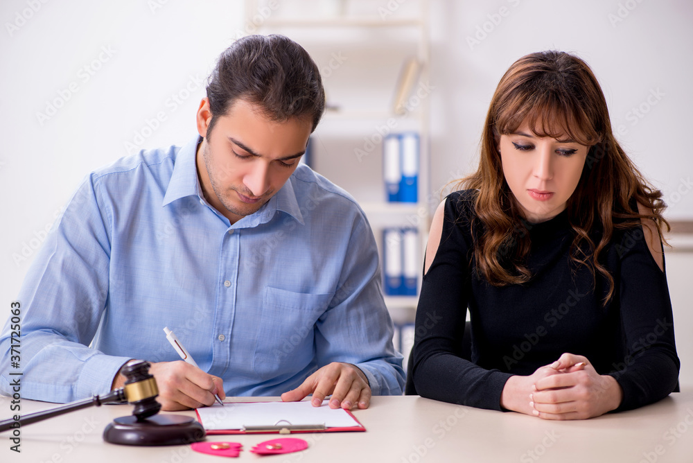 Young pair in courthouse in divorcing concept Young pair in courthouse in divorcing concept