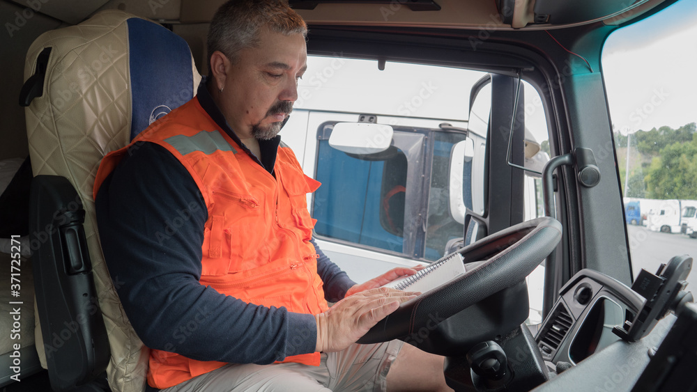 Trucker sitting front of the driving wheel Trucker sitting front of the driving wheel