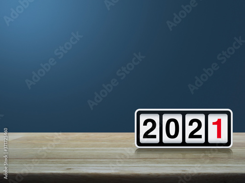 Retro flip clock with 2021 text on wooden table over light blue gradient background, Happy new year 2021 cover concept
