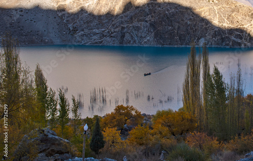  Atabad lake panoramic view with boats , autumn landscape with sky and clouds in upper hunza, gojal , gilgit baltistan	 photo