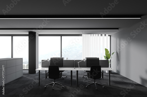 Workspace in grey open space office © ImageFlow
