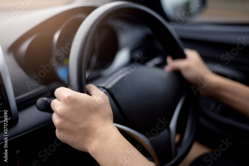 Background of human hand is holding car steering . © tonefotografia