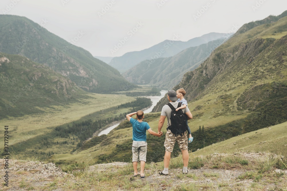 Father and two sons in the mountains