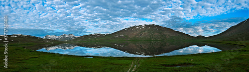 sheosar lake deosai plains , panoramic view of lake with  reflection of clouds and blue sky  photo