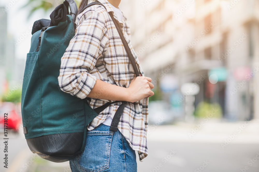 Side view of Alone young woman travel in holiday with backpack. She walking alone in the city. Side view of Alone young woman travel in holiday with backpack. She walking alone in the city.