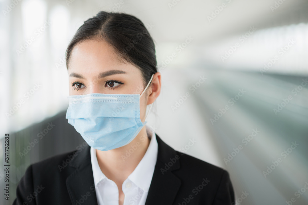 Business woman wearing protection mask. Beautiful female protective virus and pollution with face mask.