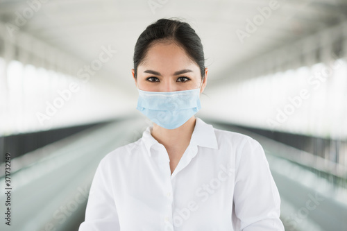Business woman wearing protection mask. Beautiful female protective virus and pollution with face mask.