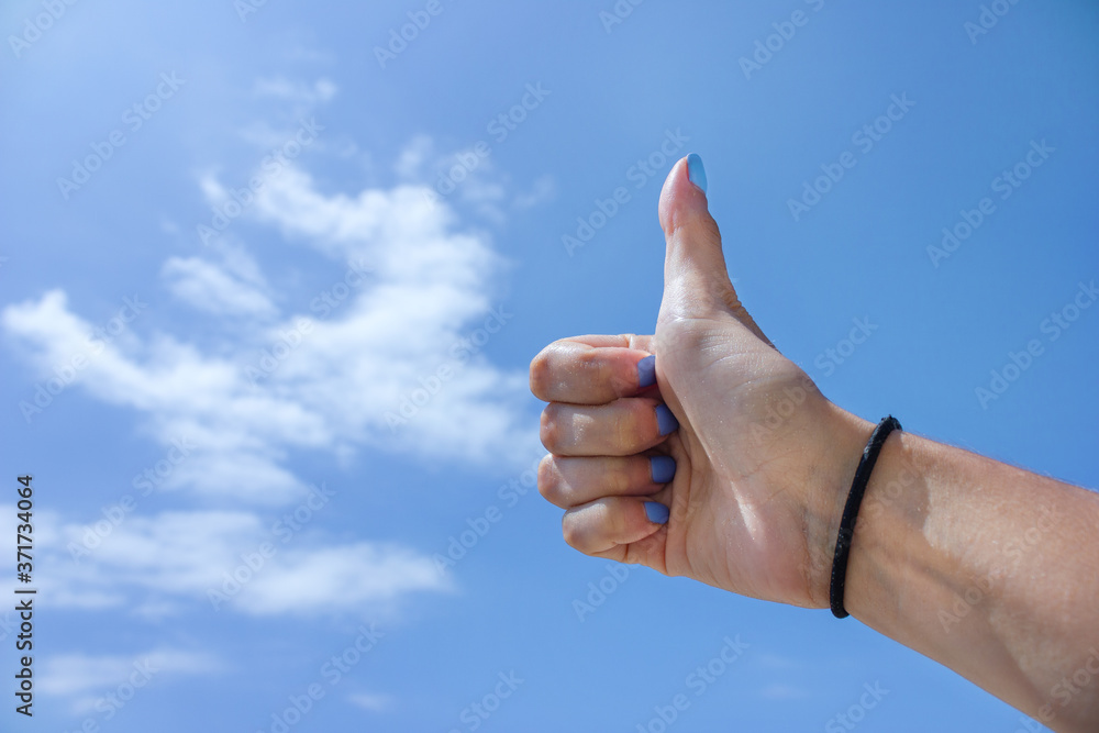 Hands on blue sky background, thumbs up Hands on blue sky background, thumbs up