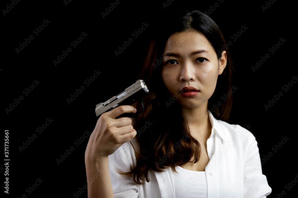 Portrait asian woman hand holding a pistol gun Portrait asian woman hand holding a pistol gun