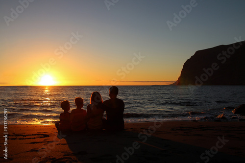 Happy family on the beach during sunset © Amo