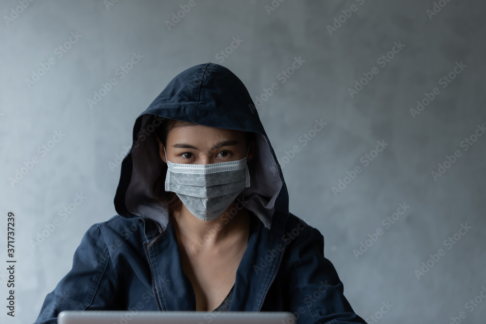 Hacker women stealing data by using laptop.