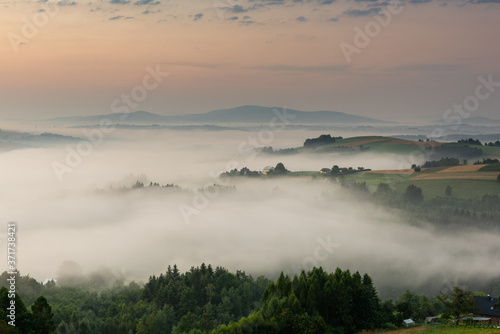 Countryside and Meadows in Morning Fog and Mist at Beautiful Sunrise