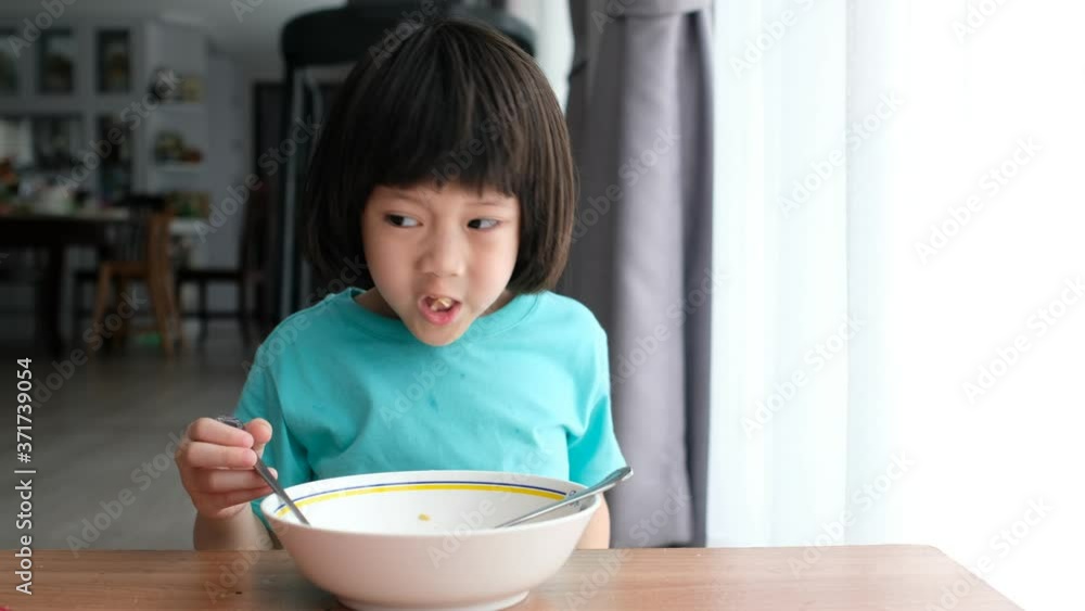 Asian kid eating noodles with blur background
Asian kid eating noodles with blur background