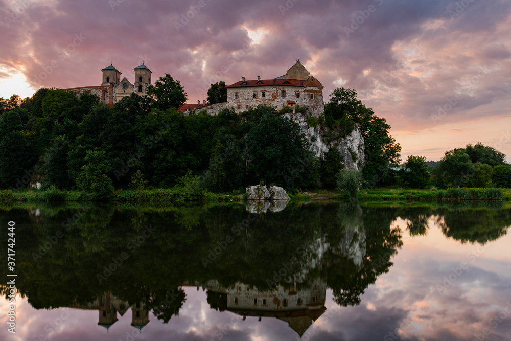 Benedictine Abbey and Monastery on the Hill in Tyniec near Cracow, Poland. Riverside of Vistula River at Sunrise