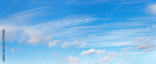 blue sky with fluffy clouds and cirrus