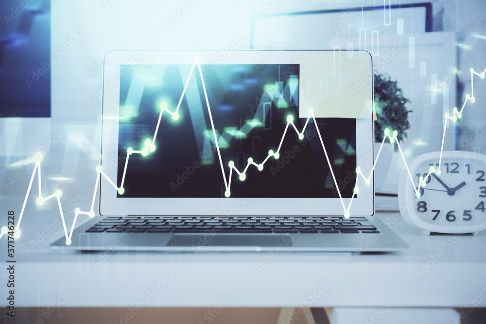 Forex Chart hologram on table with computer background. Double exposure. Concept of financial markets. Forex Chart hologram on table with computer background. Double exposure. Concept of financial markets.