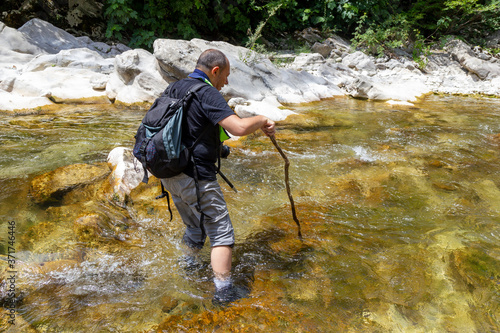 hiker standing in the water of a fiome in the gorges of the calore in Cilento © ciroorabona