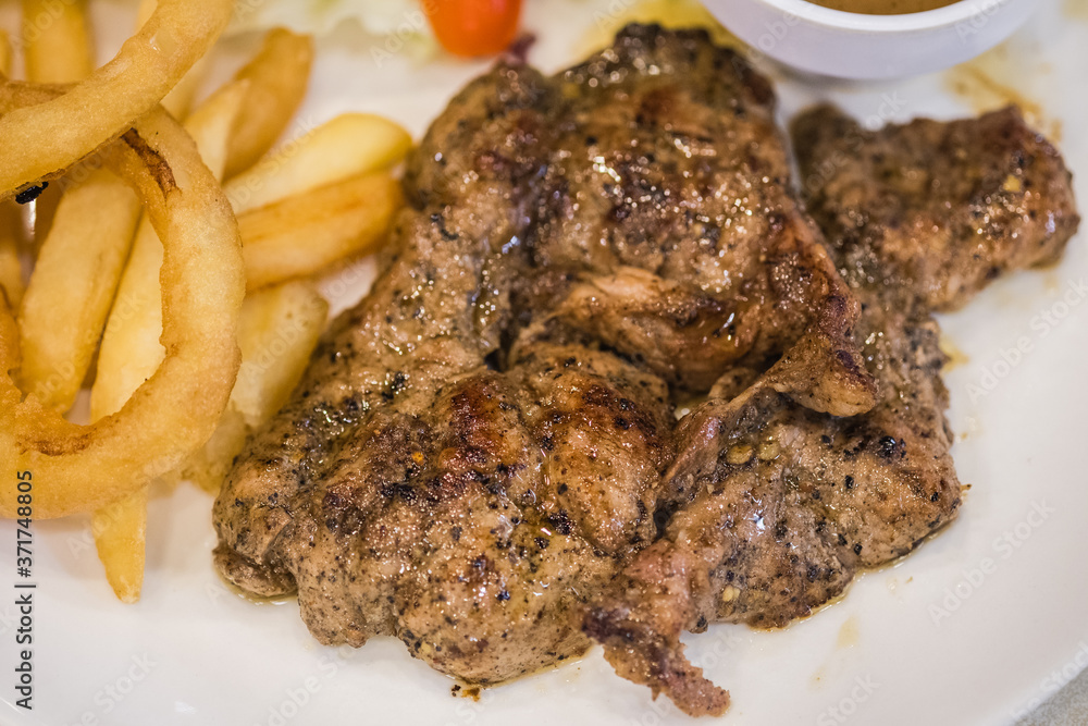 Pork steak set with black pepper sauce served with potato and some vegetable Pork steak set with black pepper sauce served with potato and some vegetable