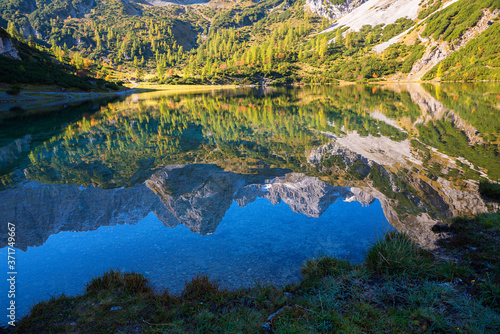 alpine range reflecting in water of lake Seebensee, autumnal landscape austria near Ehrwald