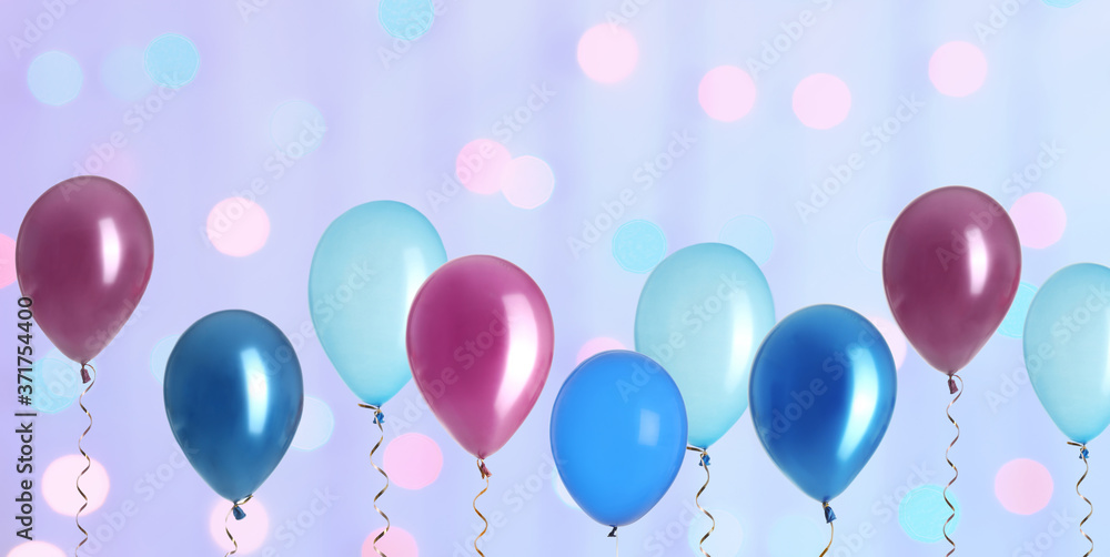 Bright balloons on color background with bokeh effect. Banner design