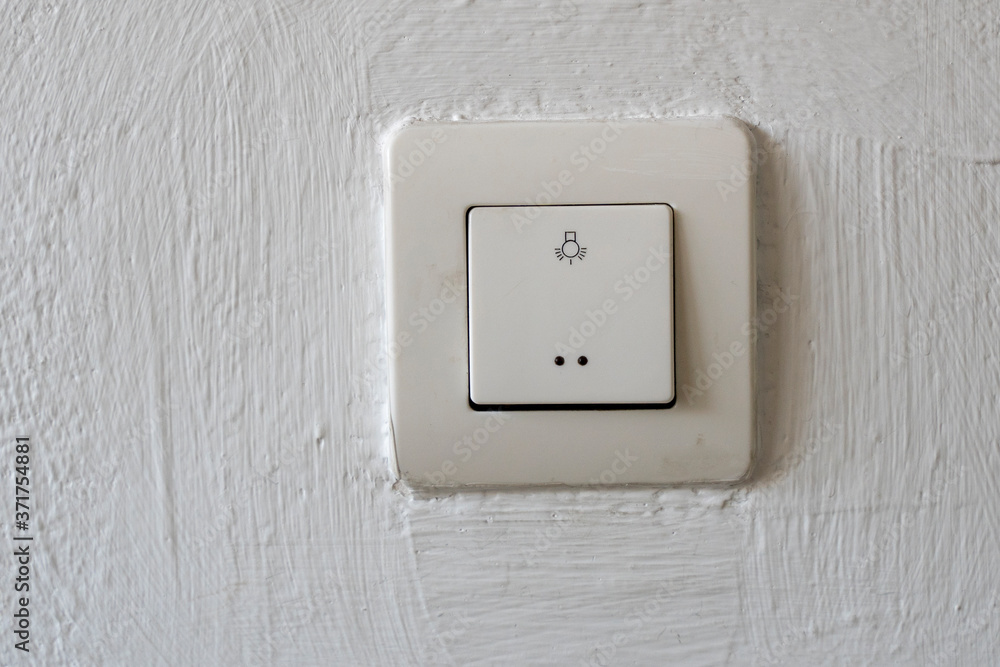 Old plastic switch with a bulb symbol. Close-up. Old plastic switch with a bulb symbol. Close-up.