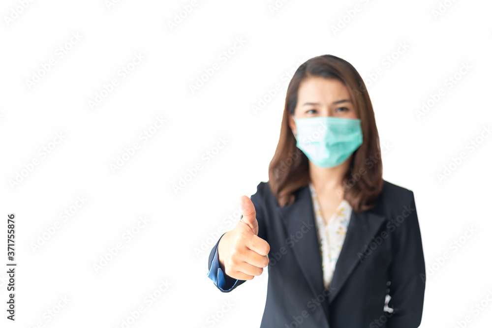 Help stop the spread of coronavirus disease worldwide On the background, the woman in the mask focuses on a hand with a thumbs up, showing readiness to fight disease. Health care concept. Help stop the spread of coronavirus disease worldwide On the background, the woman in the mask focuses on a hand with a thumbs up, showing readiness to fight disease. Health care concept.