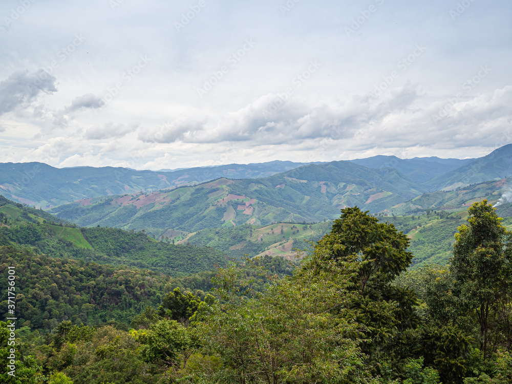 Scenic view of mountains against cloud sky Scenic view of mountains against cloud sky