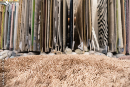 Carpets assortment on the store counter close up abstract background.