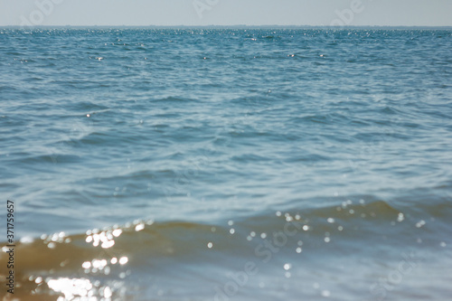 Close-up of sand on the beach and water of the Yarovoe salt lake (Altai Territory).