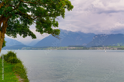 Beautiful view of Thuner lake, Canton of Bern, Switzerland, with cloudy sky in late afternoon.

