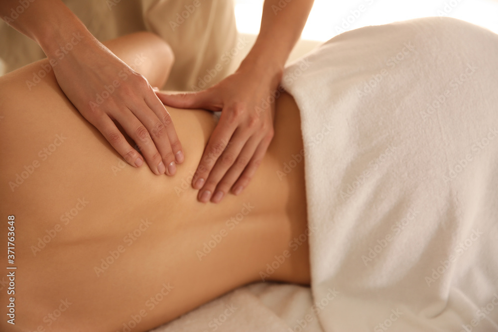 Young woman receiving back massage in spa salon, closeup Young woman receiving back massage in spa salon, closeup