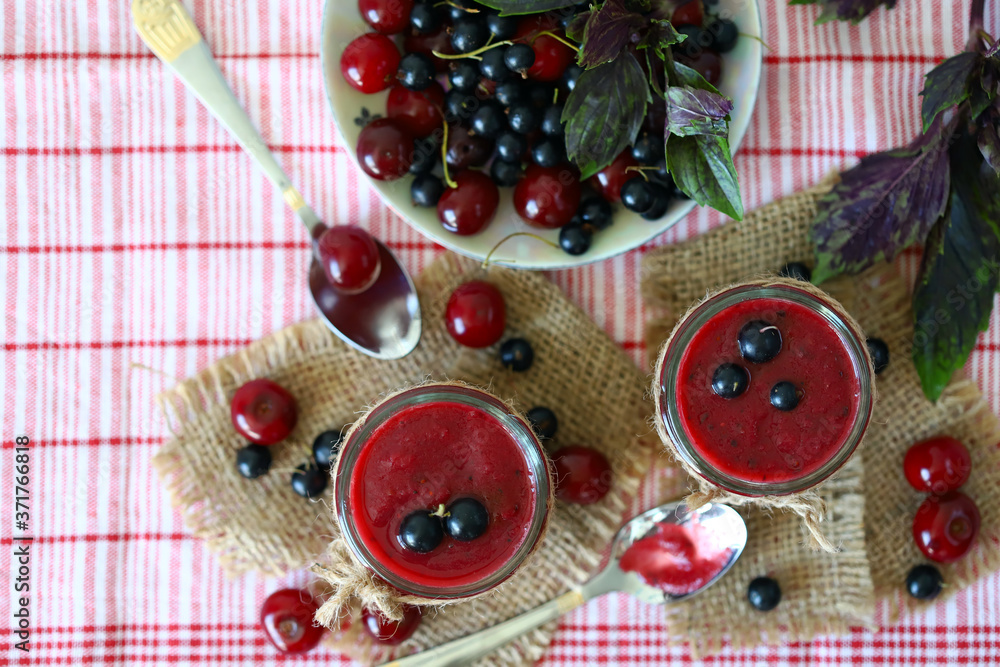 Selective focus. Macro. Smoothie jars. Black currant cherry smoothie. Healthly food. Vegan diet. Healthy summer dessert. Selective focus. Macro. Smoothie jars. Black currant cherry smoothie. Healthly food. Vegan diet. Healthy summer dessert.
