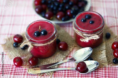 Selective focus. Macro. Smoothie jars. Black currant cherry smoothie. Healthly food. Vegan diet. Healthy summer dessert.