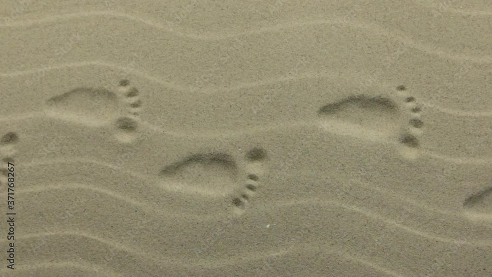 Zoom. Human prints on the sand dunes. Crane shot. Top view Zoom. Human prints on the sand dunes. Crane shot. Top view