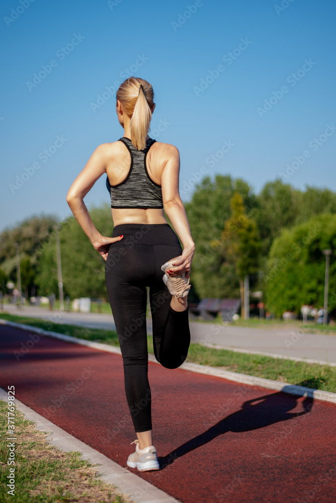 Woman stretching her legs  outdoors.