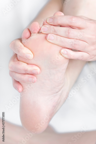 Bare feet feel pain with foot massage