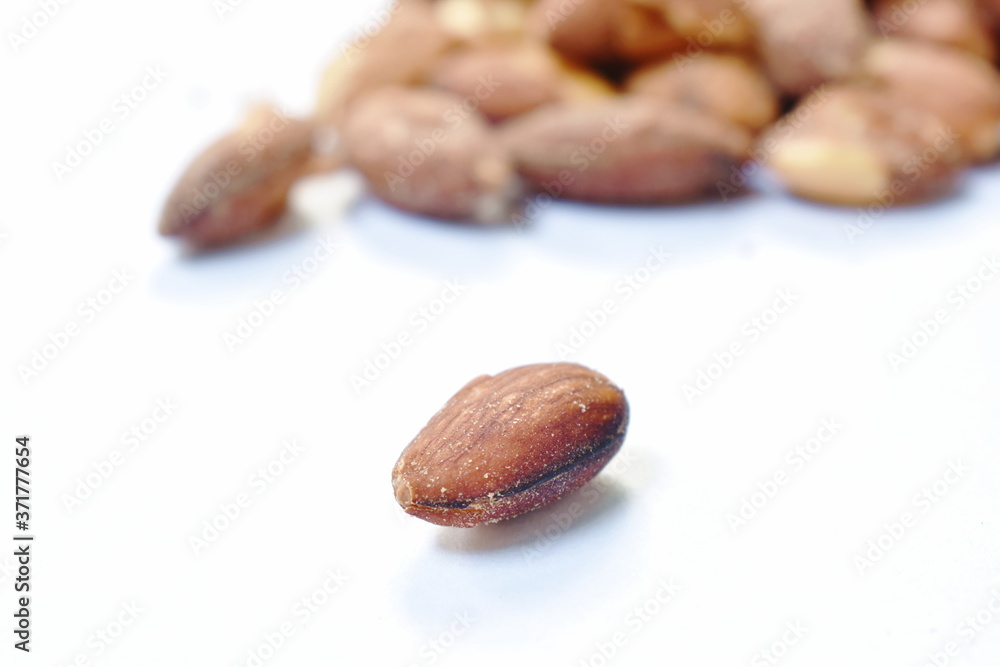Obraz premium baked almond seed batch on white background