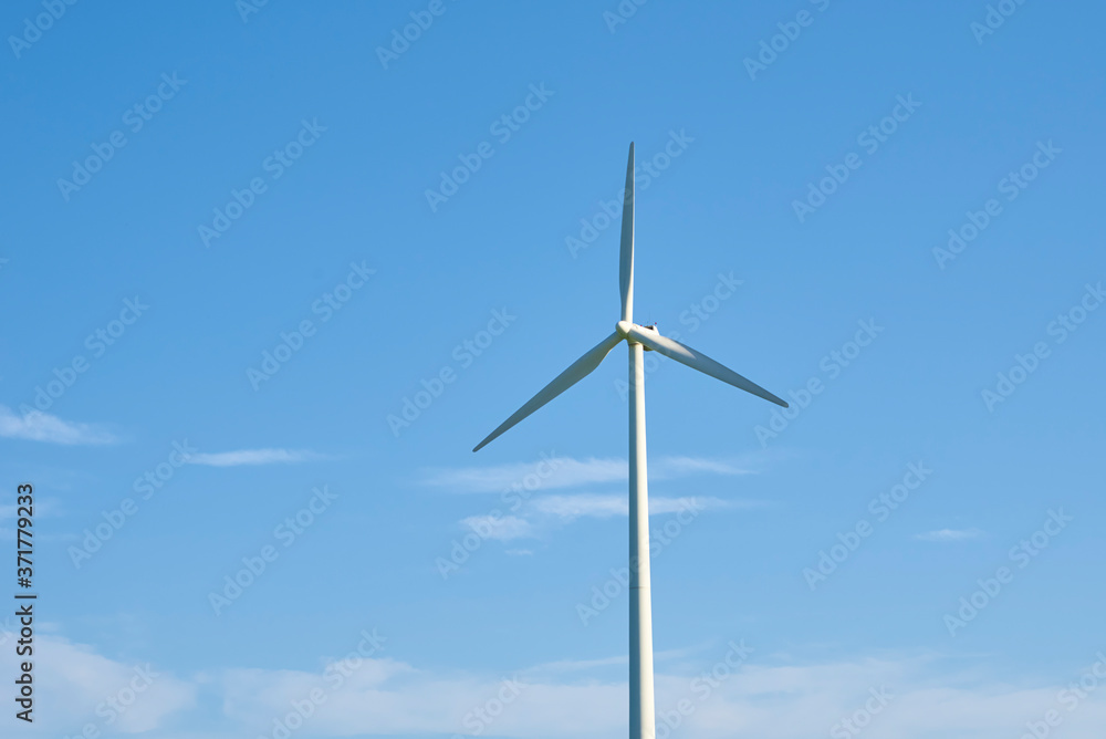 Wind turbine against blue sky. Wind power energy concept