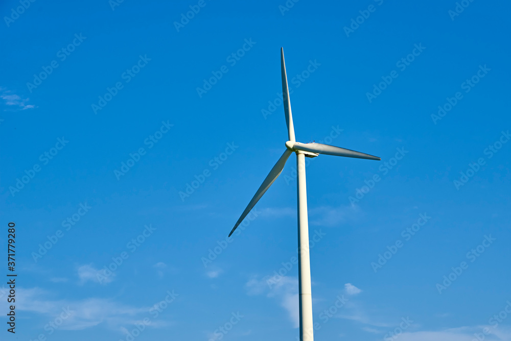 Wind turbine against blue sky. Wind power energy concept