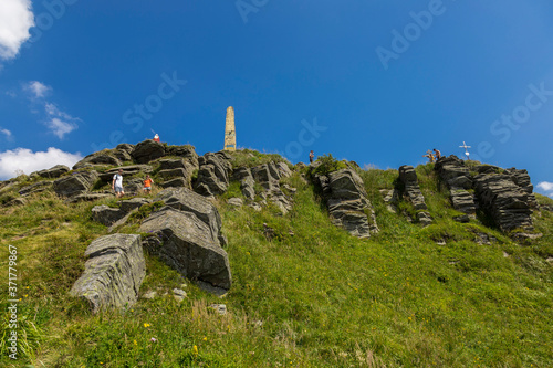 Summer landscape of the Carpathians on a sunny day. The main watershed. Mount Pikuy, Ukraine. Rock ledges on a background of mountains. Landscape with high mountains. photo