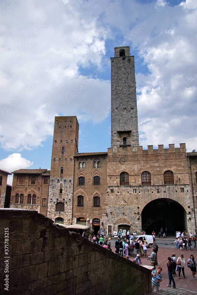 Tourists at the famous Piazza Della Cisterna square in the historic town of San Gimignano, Tuscany, Italy, Europe