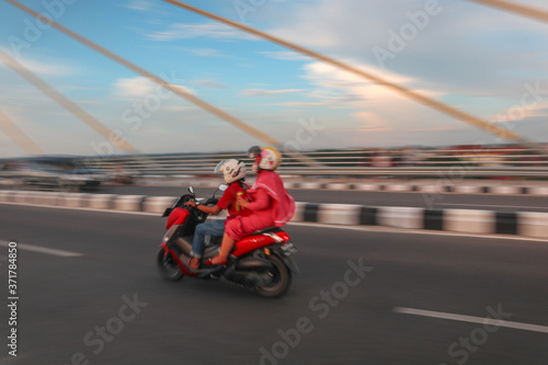 couple motorcycles on the road. panning