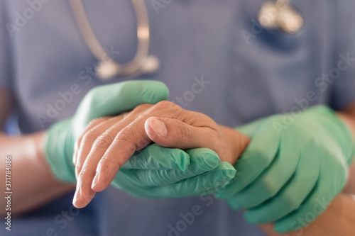 Surgeon, physician performs surgical operations, anesthetist or anesthesiologist holding patient's hand ffor checking state of mand or support in ER room, Medical healthcare concept photo