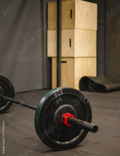 Fitness equipment for workout in Gym. Barbell with weights plate on floor. Fitness concept.